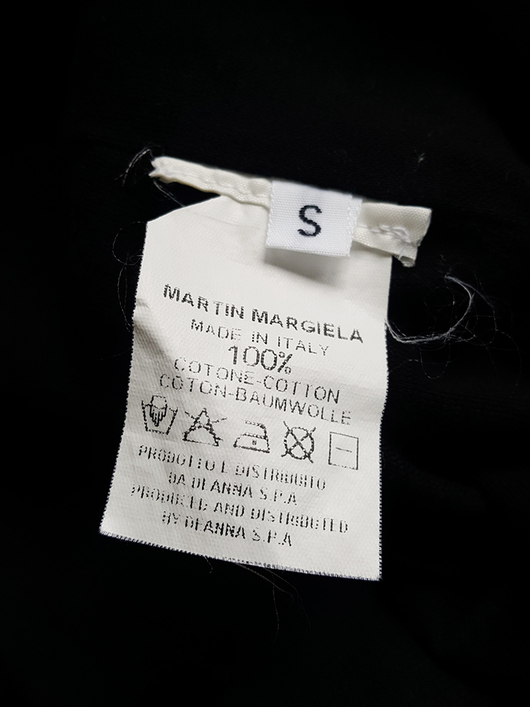 Maison Martin Margiela black t-shirt hanging on the front of the body ...
