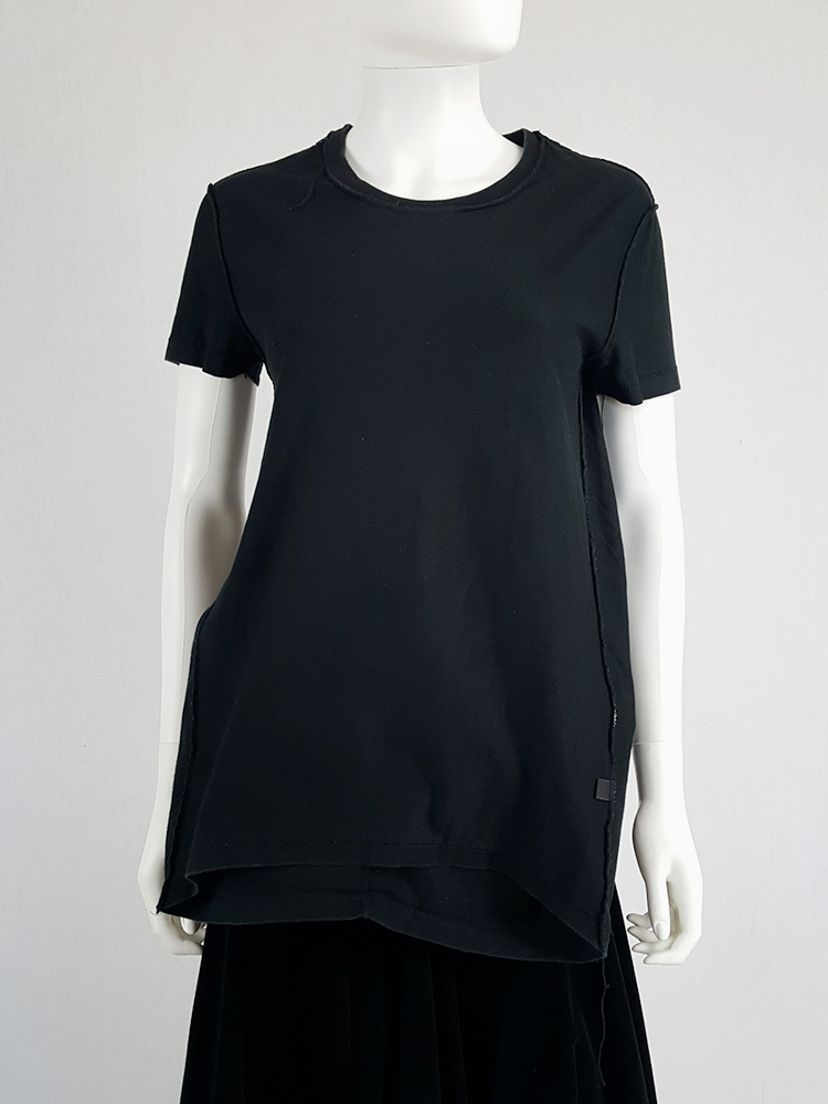 Maison Martin Margiela black t-shirt hanging on the front of the body ...