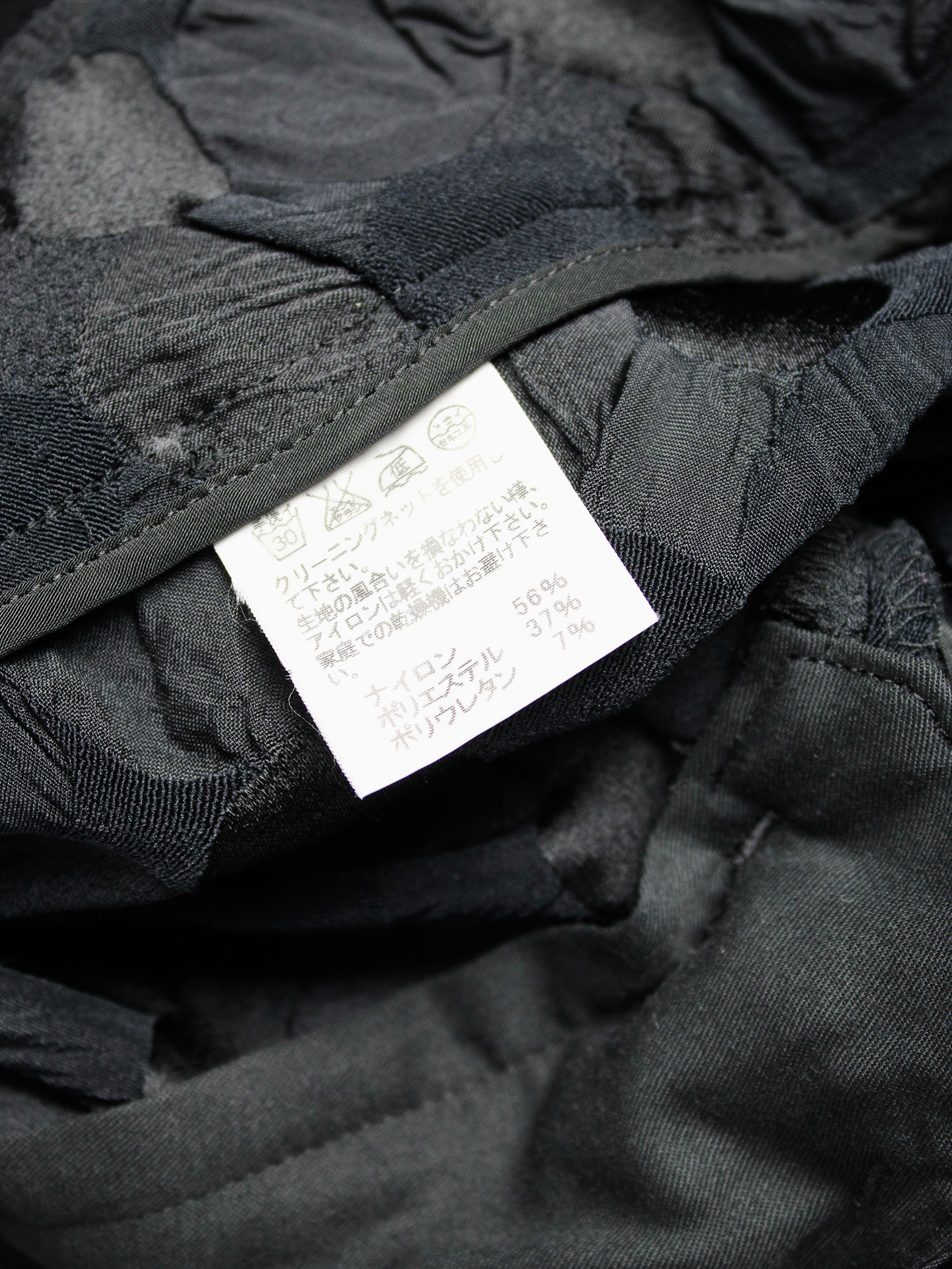 Issey Miyake black trousers with the fabric manipulated into different ...