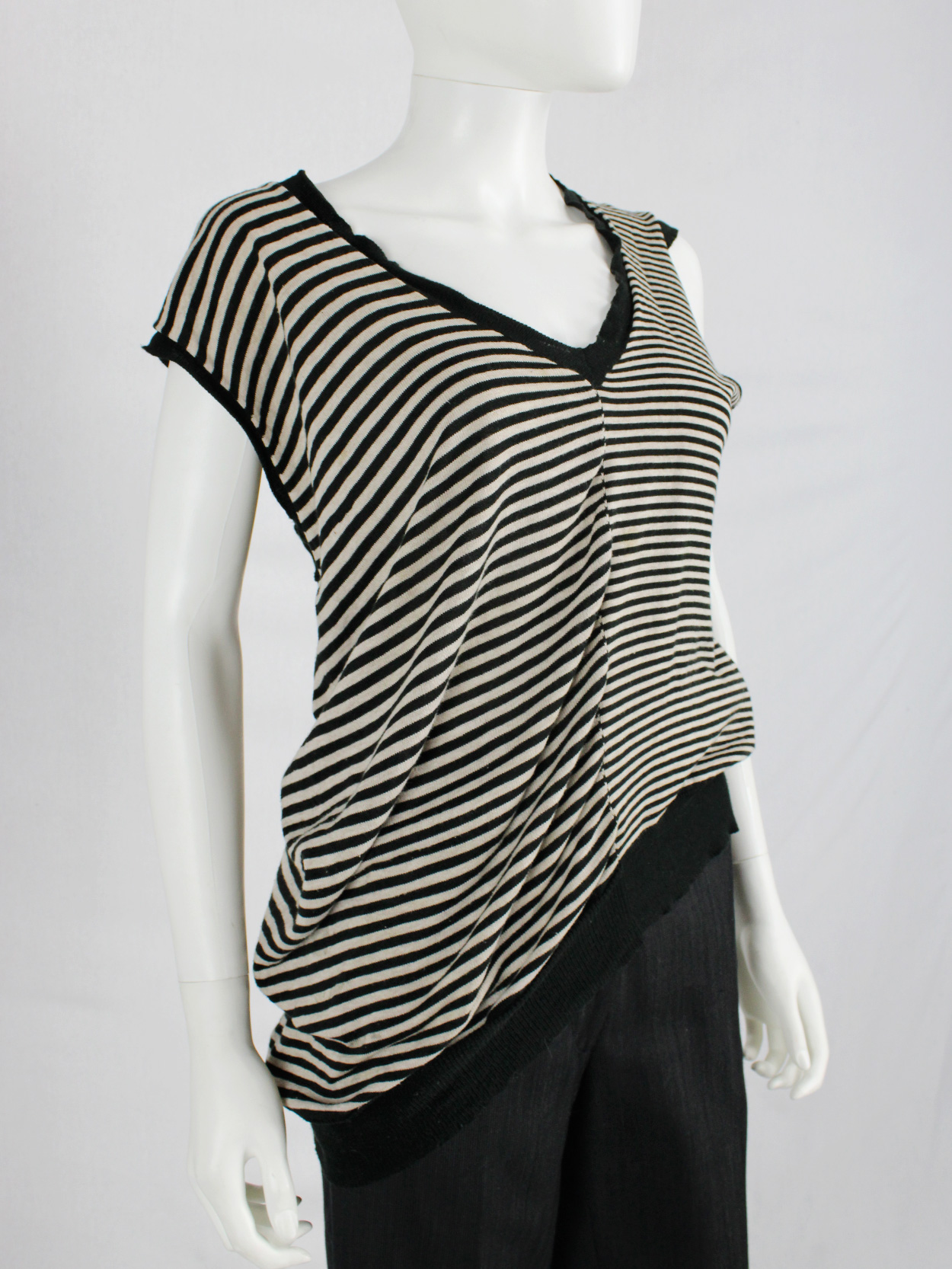Maison Martin Margiela beige and black striped top, stretched out on ...