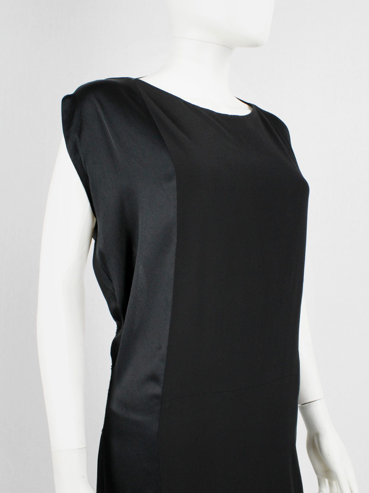 Maison Martin Margiela black backless dress with straps modeled after a ...