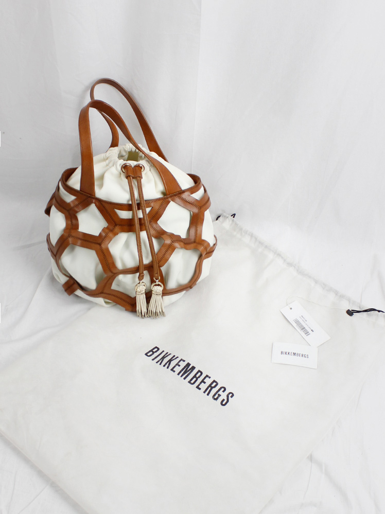 vintage Dirk Bikkembergs brown leather football bag with hexagonal cutouts over a white fabric bag (1)